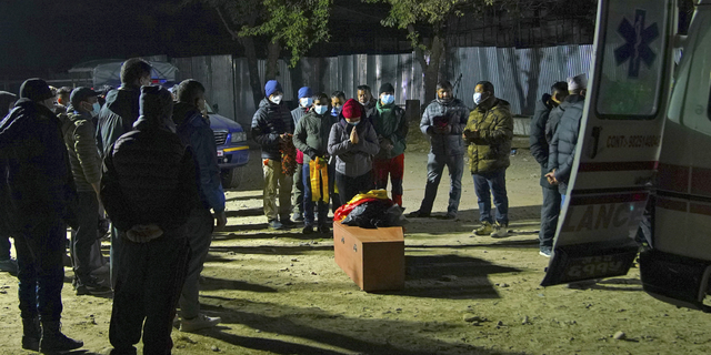 Family members receive the body of a victim of Sunday's plane crash in Pokhara, Nepal.