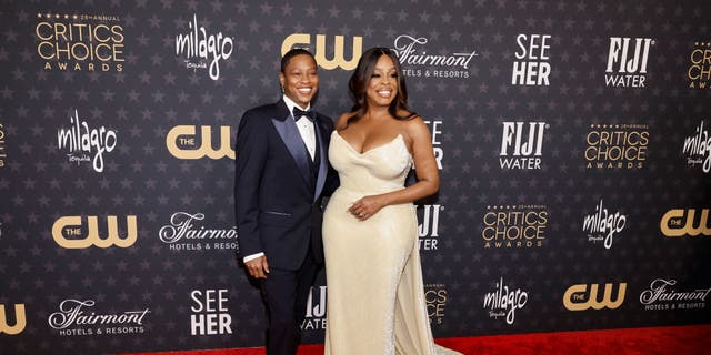Jessica Betts and Niecy Nash-Betts shake hands at the Critics Choice Awards.