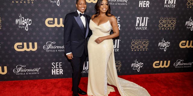 Jessica Betts and Niecy Nash-Betts shake hands at the Critics Choice Awards.