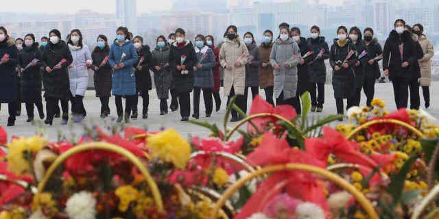 North Koreans visit the statues of late leaders Kim Il Sung and Kim Jong Il in Pyongyang, North Korea, on, Jan. 22, 2023. Russia’s embassy in North Korea says the country has eased epidemic controls that were placed to slow the spread of respiratory illnesses. 