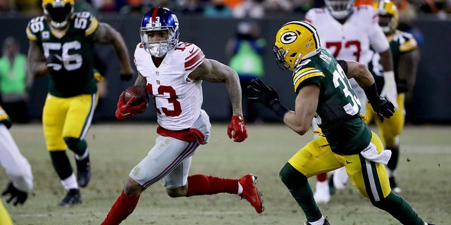 GREEN BAY, WI - JANUARY 8: Odell Beckham #13 of the New York Giants runs with the ball while being chased by Micah Hyde #33 of the Green Bay Packers in the third quarter during the NFC Wild Card game at Lambeau Field on 8 January 2017 in Green Bay, Wisconsin.