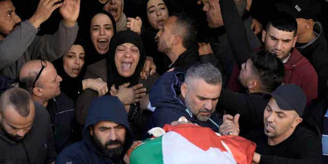 Palestinian women mourn for schoolteacher Jawad Bawaqna, 57, and Adham Jabareen, 28, during their funeral in the West Bank city of Jenin, on Jan. 19, 2023. Both of them were killed by Israeli troops.