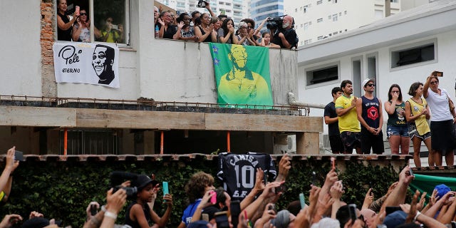 Pele's sister Maria Lucia Nascimento, family and friends say goodbye to Brazilian soccer legend Pele as his coffin is carried by the fire department past the home of his mother, Celeste Arantes.