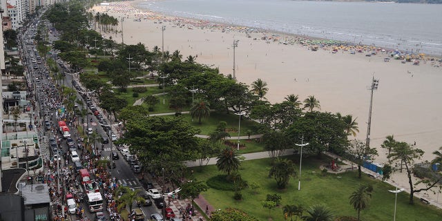 General view of fans as the fire department transports the coffin of Brazilian soccer legend Pelé.