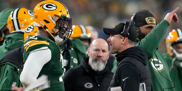 Packers head coach Matt LaFleur talks with Quay Walker after he was disqualified for an unsportsmanlike penalty at Lambeau Field on Jan. 8, 2023, in Green Bay, Wisconsin. (Patrick McDermott/Getty Images)