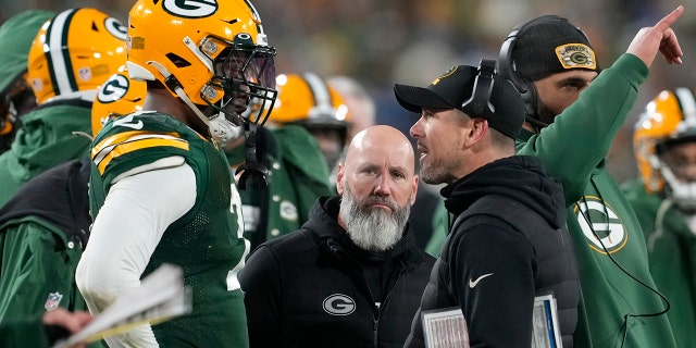 Packers head coach Matt LaFleur talks with Quay Walker after he was disqualified for an unsportsmanlike penalty at Lambeau Field on Jan. 8, 2023, in Green Bay, Wisconsin. (Patrick McDermott/Getty Images)