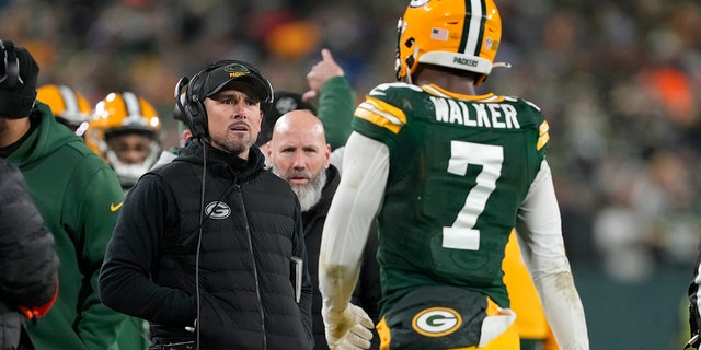 Head coach Matt LaFleur of the Packers talks with Quay Walker after he was disqualified for an unsportsmanlike penalty during the Detroit Lions game at Lambeau Field on Jan. 8, 2023, in Green Bay, Wisconsin.