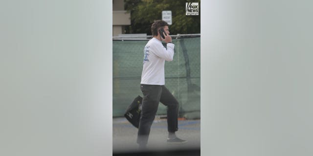 Riley Keough’s husband Ben Smith-Petersen talks on the phone near the hospital.