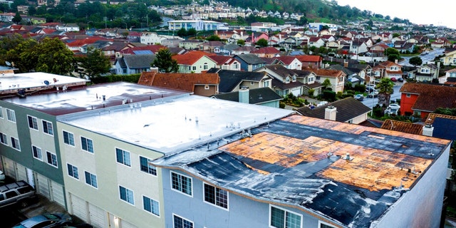 Exposed roofing tops a South San Francisco, Calif., apartment building as storms continue battering the state on Jan. 10, 2023.