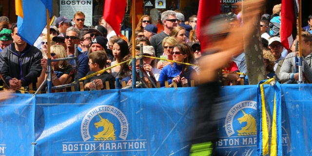 Boston Marathon runner appears to take bathroom break on someone's front lawn 3 BOSTON - APRIL 21: At the Boston Marathon at the finish line ground level on Boylston Street, runners pass the site of last years first bombing in front of Marathon Sports.