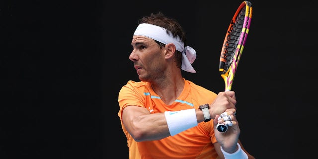 Rafael Nadal of Spain plays a backhand in their round one singles match against Jack Draper of Great Britain during day one of the 2023 Australian Open at Melbourne Park on January 16, 2023, in Melbourne, Australia.