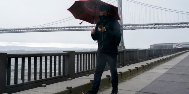 A person walks on The Embarcadero in San Francisco, Wednesday, Jan. 4, 2023.