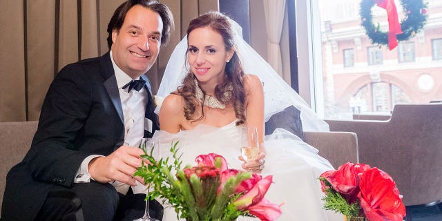 Brian and Ana Walshe raise a toast on their wedding day in the lounge of L'Espalier in Boston, Massachusetts on Monday, Dec. 21, 2015.