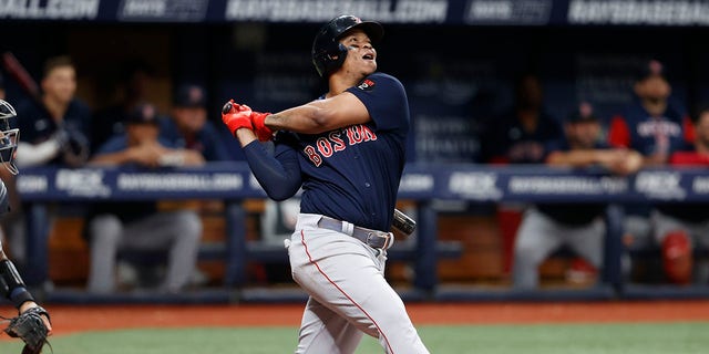 Rafael Devers of the Boston Red Sox watches his RBI single against the Tampa Bay Rays during a game Sept. 5, 2022, in St. Petersburg, Fla. The Sox have agreed to a one-year contract with the two-time All-Star that avoided salary arbitration.