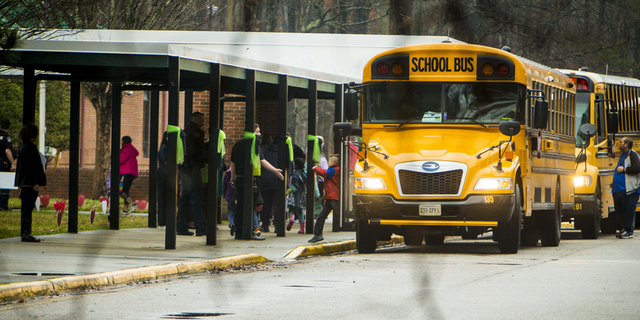Students exit a school bus during the first day back to Richneck Elementary School on Monday Jan. 30, in Newport <a href=