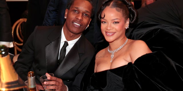 Rihanna and A$AP Rocky cuddle up at the Golden Globe Awards.