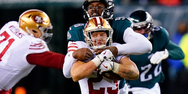San Francisco 49ers running back Christian McCaffrey (23) is tackled by Philadelphia Eagles defensive end Robert Quinn during the second half of the NFC Championship NFL football game between the Philadelphia Eagles and the San Francisco 49ers on Sunday, Jan. 29, 2023, in Philadelphia.
