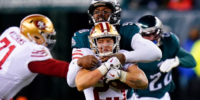 San Francisco 49ers running back Christian McCaffrey (23) is tackled by Philadelphia Eagles defensive end Robert Quinn during the second half of the NFC Championship NFL football game between the Philadelphia Eagles and the San Francisco 49ers on Sunday, Jan. 29, 2023, in Philadelphia.