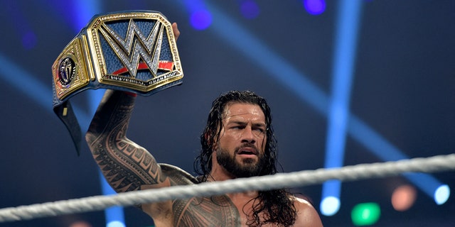 Roman Reigns celebrates after defeating Bill Goldberg during the 2022 WWE Elimination Chamber at the Jeddah Super Dome in Saudi Arabia's Red Sea coastal city of Jeddah on February 19, 2022.