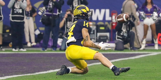 Wide receiver Roman Wilson of the Michigan Wolverines catches a pass at the 1-yard line during the VRBO Fiesta Bowl against the TCU Horned Frogs on December 31, 2022 at State Farm Stadium in Glendale, Arizona.