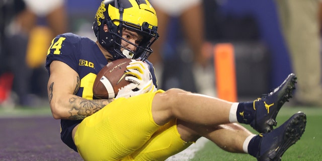 Roman Wilson of the Michigan Wolverines goes down again in the end zone against the TCU Horned Frogs on December 31, 2022 in Glendale, Arizona.