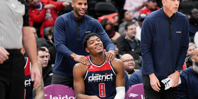 A member of the Wizards staff massages forward Rui Hachimura after he exited the Orlando Magic game, Saturday, Jan. 21, 2023, in Washington. 
