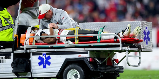 Russell Gage #17 of the Tampa Bay Buccaneers is carried off the field after suffering an injury against the Dallas Cowboys during the fourth quarter in the NFC Wild Card playoff game at Raymond James Stadium on January 16, 2023 in Tampa, Florida.