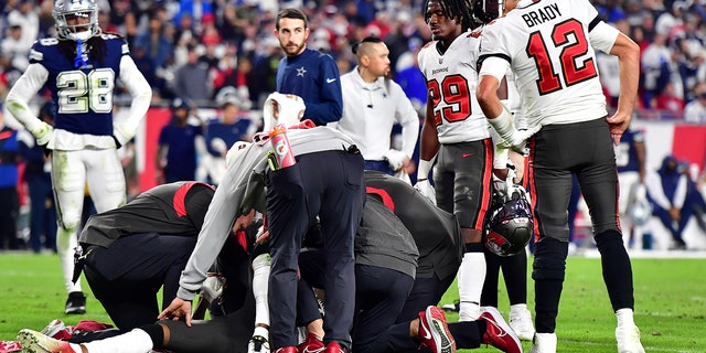 Buccaneers' Tom Brady looks on during an injury timeout for teammate Russell Gage in the wild card playoff game against the Dallas Cowboys at Raymond James Stadium on January 16, 2023 in Tampa.