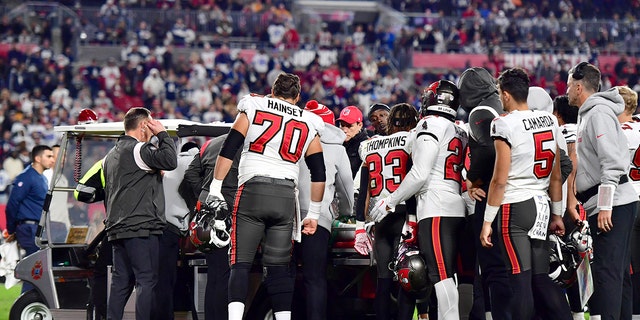 Russell Gage #17 of the Tampa Bay Buccaneers is carried off the field after suffering an injury against the Dallas Cowboys during the fourth quarter in the NFC Wild Card playoff game at Raymond James Stadium on January 16, 2023 in Tampa, Florida.