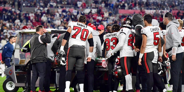 Russell Gage #17 of the Tampa Bay Buccaneers is carried off the field after suffering an injury against the Dallas Cowboys during the fourth quarter in the NFC Wild Card playoff game at Raymond James Stadium on January 16, 2023 in Tampa, Florida.