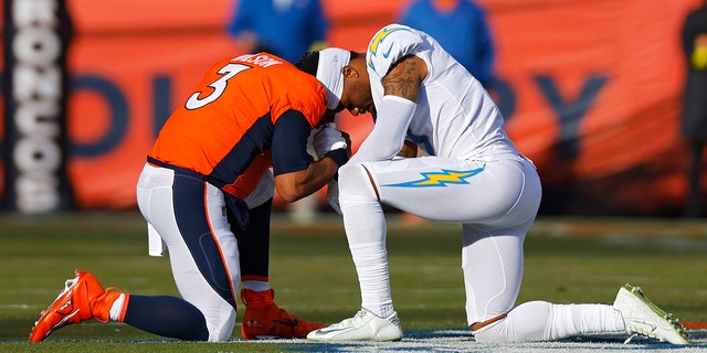 Russell Wilson #3 of the Denver Broncos and Derwin James Jr. #3 of the Los Angeles Chargers pray before their game at Empower Field At Mile High on January 8, 2023 in Denver, Colorado.