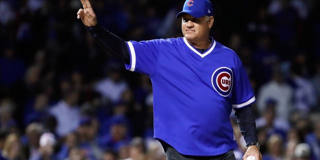 Former Cubs player Ryne Sandberg waves before throwing out a ceremonial first pitch before the National League Championship Series game between Los Angeles and Chicago at Wrigley Field on Oct. 18, 2017.