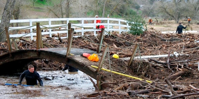 Rescuers search on Wednesday, Jan. 11, 2023, for 5-year-old Kyle Doan, who was swept away Monday, Jan. 9, by floodwaters.