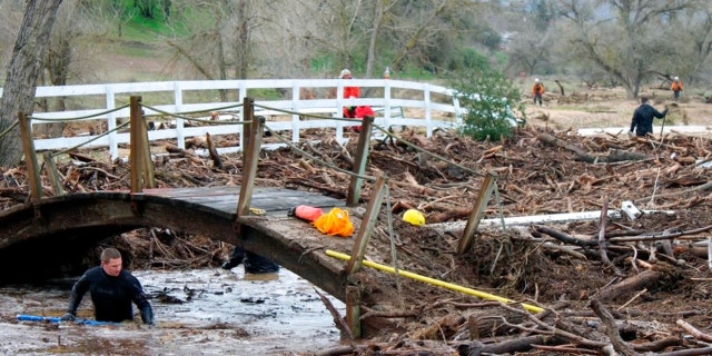 Rescuers search on Wednesday, Jan. 11, 2023, for 5-year-old Kyle Doan, who was swept away Monday, Jan. 9, by floodwaters.