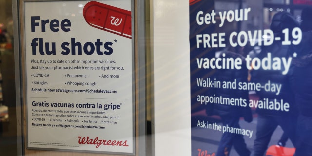 Flu and coronavirus (COVID-19) vaccine signage is seen at a Duane Reade by on Broadway on Jan. 5, 2023, in New York City.