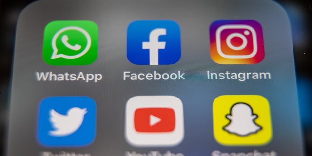 In this photo illustration, the logos of Facebook, WhatsApp and Instagram are displayed on a smartphone screen on March 14, 2022 in Glastonbury, England. 