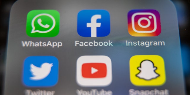 In this photo illustration, the logos of Facebook, WhatsApp and Instagram are displayed on a smartphone screen March 14, 2022, in Glastonbury, England. 