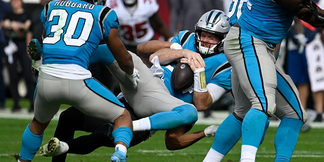 Carolina Panthers quarterback Sam Darnold is sacked by Buccaneers safety Antoine Winfield Jr., Sunday, Jan. 1, 2023, in Tampa.