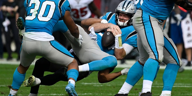 Carolina Panthers quarterback Sam Darnold is sacked by Buccaneers safety Antoine Winfield Jr., Sunday, Jan. 1, 2023, in Tampa.