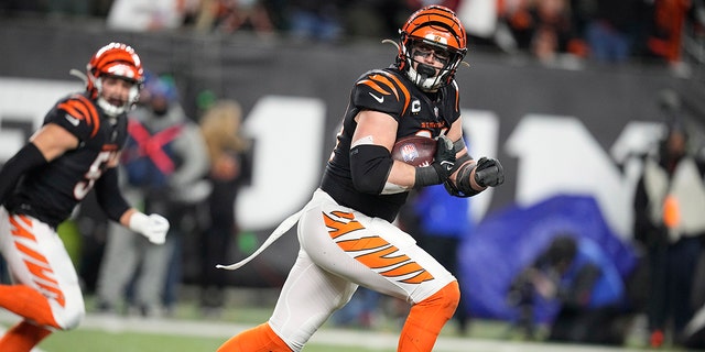 Cincinnati Bengals defensive end Sam Hubbard runs a fumble by Baltimore Ravens quarterback Tyler Huntley back 98-yards for a touchdown in the second half of an NFL wild-card playoff football game in Cincinnati, Sunday, Jan. 15, 2023. 