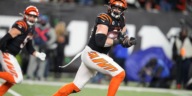 Cincinnati Bengals defensive end Sam Hubbard runs a fumble by Baltimore Ravens quarterback Tyler Huntley back 98-yards for a touchdown in the second half of an NFL wild-card playoff football game in Cincinnati, Sunday, Jan. 15, 2023. 