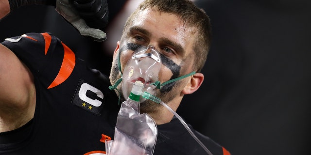 Cincinnati Bengals defensive end Sam Hubbard (94) uses oxygen after scoring 98-yard touchdown from a fumble recovery during the game against the Baltimore Ravens and the Cincinnati Bengals on January 15, 2023, at Paycor Stadium in Cincinnati, OH.