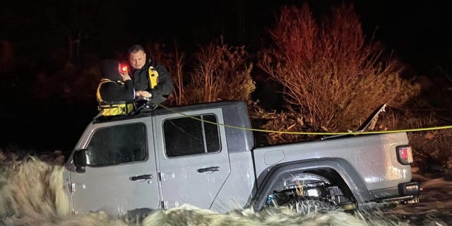San Bernardino County Fire Department crews rescue a family from floodwaters on Sunday
