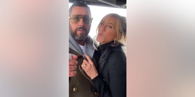 Jennifer Aniston and Adam Sandler on set "murder mystery 2," While the actress is kissing the camera.