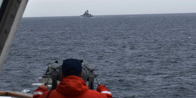 A Coast Guard Cutter Kimball crew-member spots a foreign naval vessel in the Bering Sea on Sept. 19, 2022.  