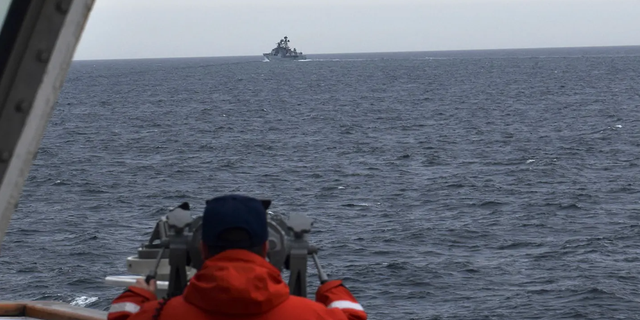 A Coast Guard Cutter Kimball crew-member spots a foreign naval vessel in the Bering Sea on Sept. 19, 2022.  