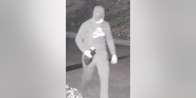 Surveillance footage from Jan. 29 allegedly shows Nicholas Malindretos approaching the temple around 3:19 a.m. while wearing a ski mask and a black hoodie. 