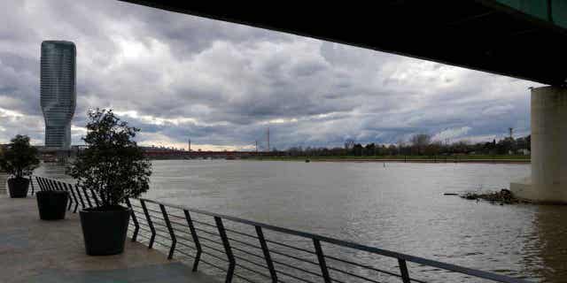 Clouds drift over the Sava river on a rainy day in Belgrade, Serbia, on Jan. 19, 2023. Emergency teams in Serbia are searching for two people who were swept away by a swollen river in the country.