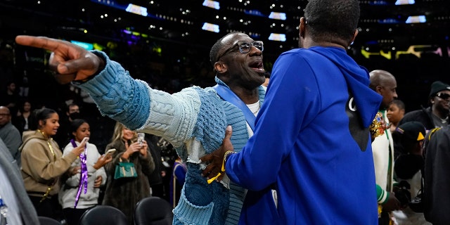 Former NFL player Shannon Sharpe, left, talks with Tee Morant, father of Memphis Grizzlies guard Ja Morant, after an NBA basketball game against the Los Angeles Lakers in Los Angeles on Friday January 20, 2023. At halftime, Sharpe faced the Memphis Grizzlies.  forward Dillon Brooks and center Steven Adams.