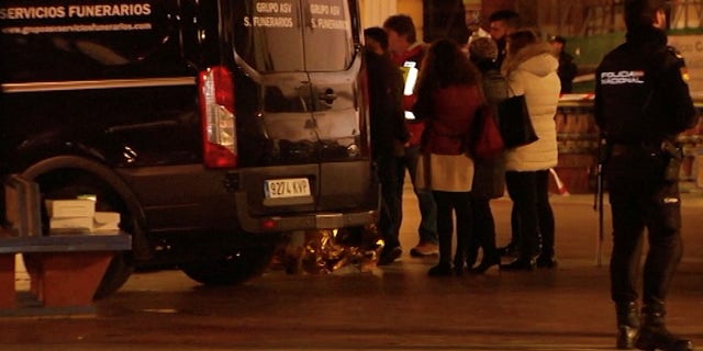 People gather next to a funeral vehicle at the scene of a stabbing incident at a church in Algeciras, Spain January 25, 2023 in this screen grab from a video.